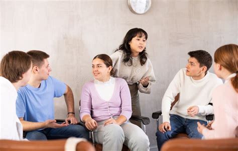 Group Of Students Engaged In Discussion In Classroom Stock Image