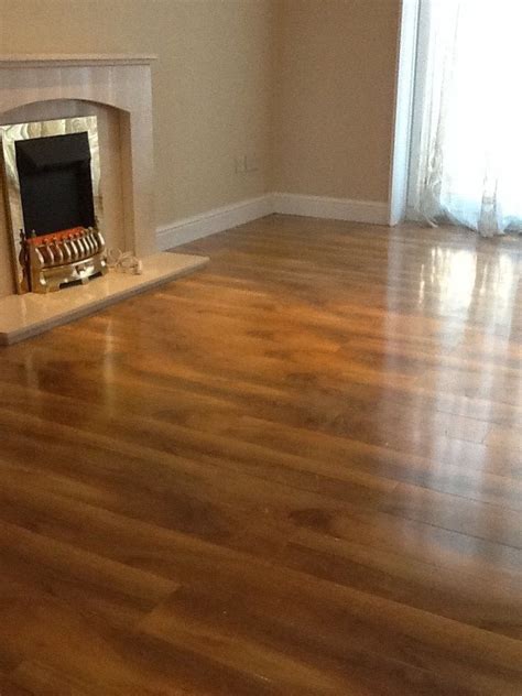 Laminate floors are built to last because they are tough enough to hold their own for years in high traffic spaces. High Gloss walnut effect laminate floor. http://www ...