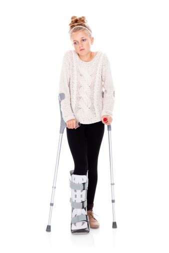 Portrait Of Sad Young Girl On Crutches Stock Photo