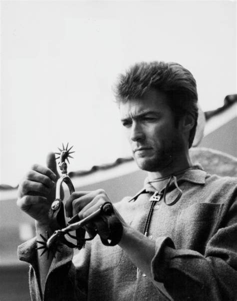 Actor Clint Eastwood Inspecting A Cowboy Boot Spur Wearing A
