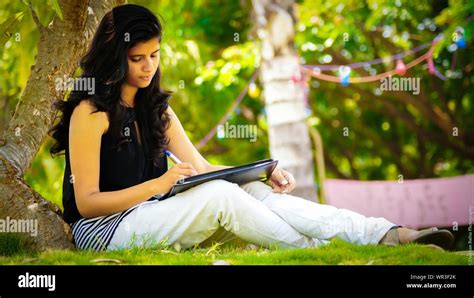 Woman Sitting Under Tree Writing Hi Res Stock Photography And Images