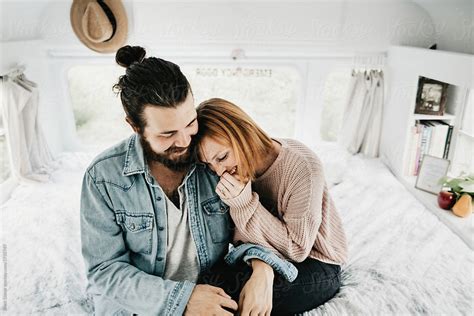 Cute Hipster Couple Cuddling In Converted School Bus Tiny Home By Stocksy Contributor Brett