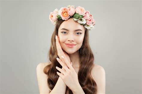 spa woman with clear skin and rose flowers on gray background spa and aromatherapy concept