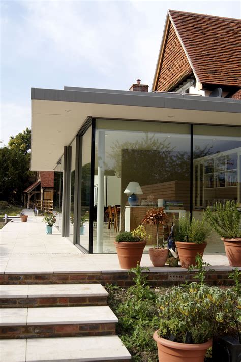Flat Roofed And Glass Walled Extension To Traditionally Built House
