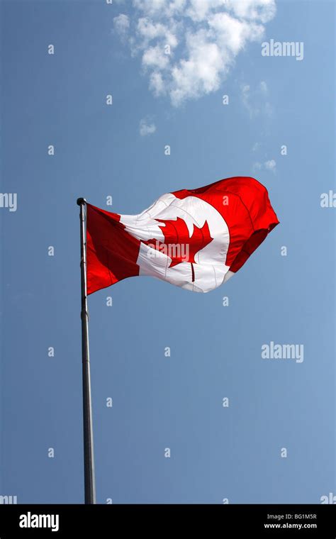 Big Canadian Flag High On The Bright Blue Sky Stock Photo Alamy