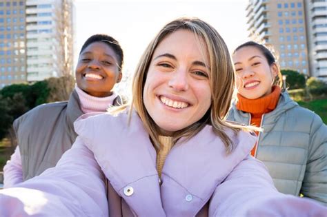 Premium Photo Three Girls Taking A Selfie Portrait Happy Looking At Camera Friendship