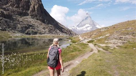 Hiker Woman Backpacker Walking To Mount Matterhorn Or Monte Cervino Or Mont Cervin And Swiss