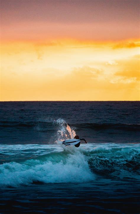 Encinitas Man Surfing On Sea Waves During Sunset United States Image