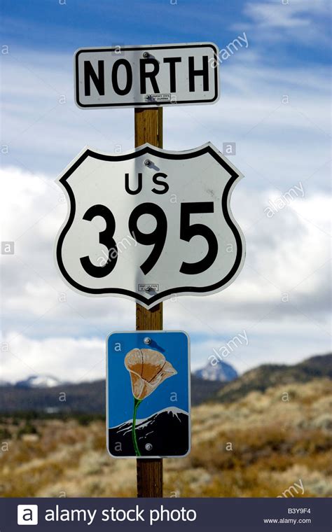 An Upward View Of A Highway 395 North Sign Post Including A California