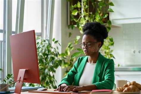 Successful African American Woman Working As Editor Magazine Typing