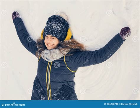 Happy Smiling Young Girl Lying In The Snow Stock Photo Image Of