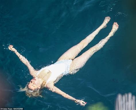 Amber Heard Highlights Her Sensational Physique In A White High Leg