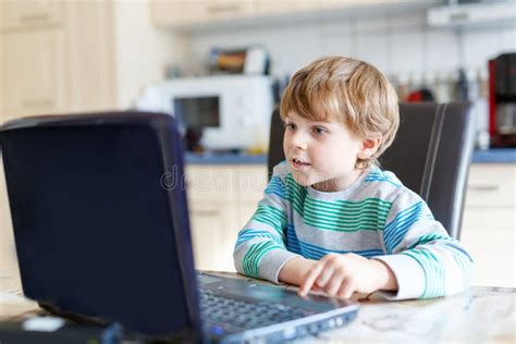 Kid Boy Surfing Internet And Playing On Computer Stock Photo Image Of