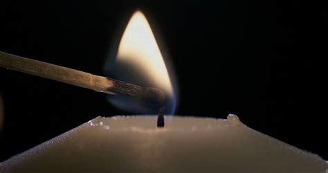 Slow Motion Macro Shot Of A Match Lighting A Candle Stock Video Footage