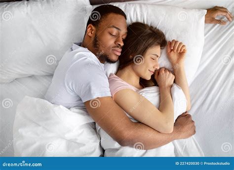 Top View Of Loving Interracial Couple Sleeping In Bed Hugging Each Other Diverse Love And