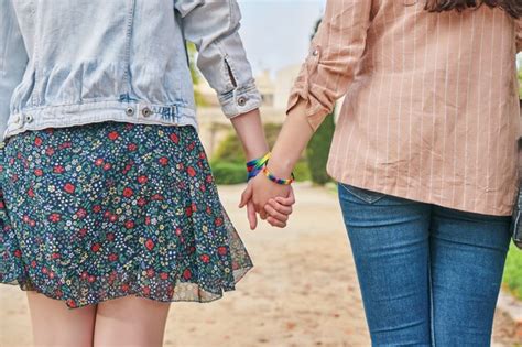 Premium Photo Lesbian Couple Walking Hand In Hand In The Park
