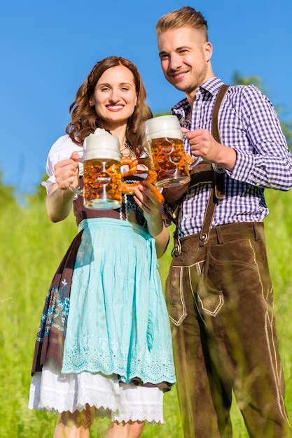 Premium Photo German Couple In Tracht With Beer And Pretzel