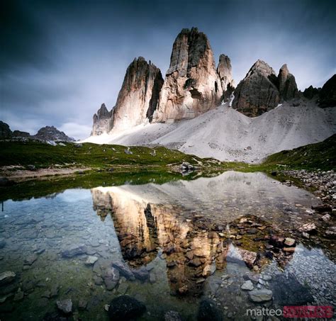 Dramatic Light Over The Three Peaks Reflected In Small Lake Dolomites