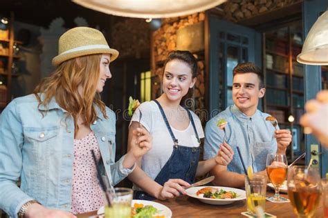 Happy Friends Eating And Drinking At Bar Or Pub Stock Image Image Of