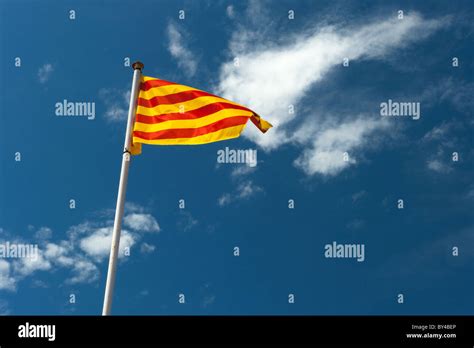Catalan Flag Blowing In The Wind On Blue Sky Stock Photo Alamy