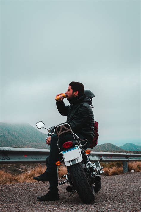 Man In Leather Jacket Drinking And Sitting On Motorcycle Motorcycle