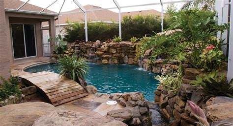 Natural Stone Pool Remodel With Wooden Bridge