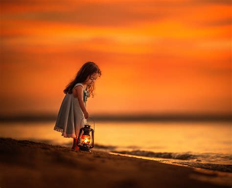 Little Girl On The Beach At Sunset
