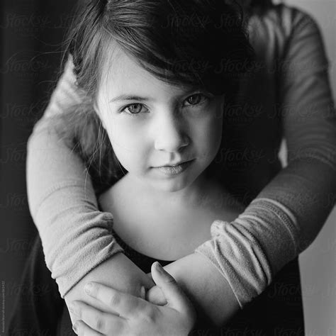 Black And White Portrait Of A Young Girl Looking At The Camera By