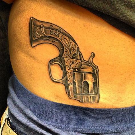 Revolver Tattoo Located On The Waist Illustrative