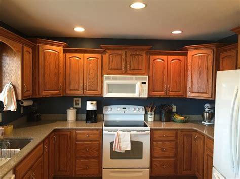Painting your current kitchen cabinets could be less expensive than buying new or even refacing them. Navy walls, Honey Oak Cabinets . Behr "Shipwreck" Home ...