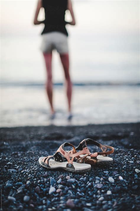 Woman Leaves Sandals On The Beach To Walk In The Water By Stocksy Contributor Mauro Grigollo