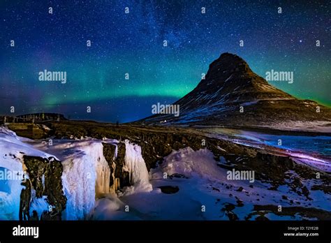 Aurora Borealis Over Kirkjufellsfoss Waterfall And Kirkjufell A