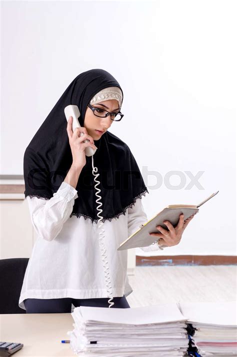 female employee in hijab working in the office stock image colourbox