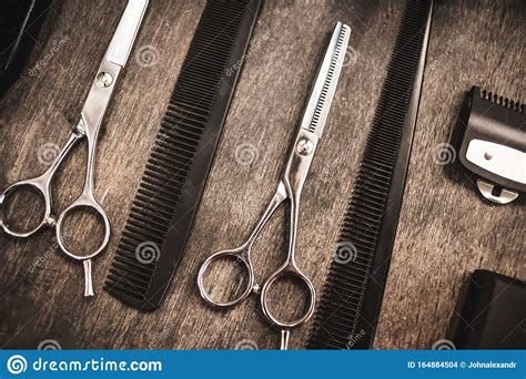 Combs And Scissors For Cutting Hair Lie On A Shelf In A Hairdressing