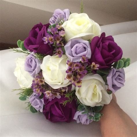 a wedding bouquet of artificial purple lilac and ivory roses lilac roses ivory roses purple