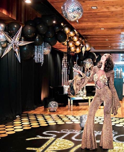 A Woman Standing On Top Of A Dance Floor In Front Of Balloons And Disco