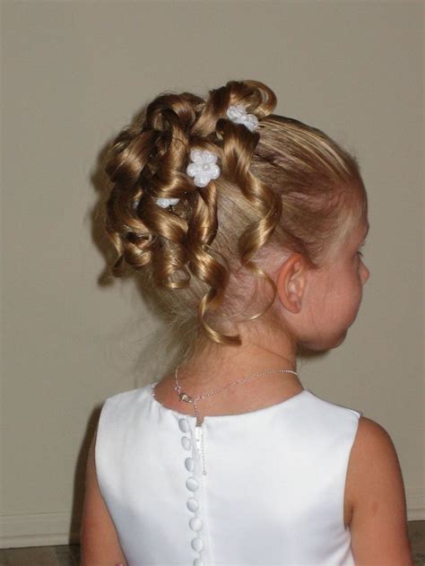Combined with a braided updo, this sophisticated look still offers an innocent tone thanks to the halo effect of the flower crown. 20 Wedding Hairstyles For Kids Ideas - Wohh Wedding