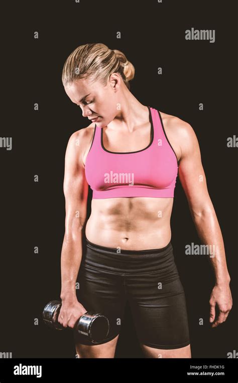 Composite Image Of Muscular Woman Lifting Heavy Dumbbell Stock Photo