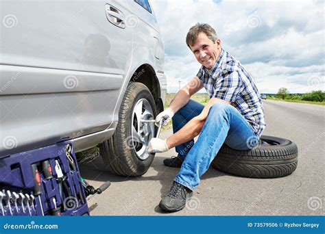 Man Changing A Spare Tire Of Car Royalty Free Stock Photography Cartoondealer Com