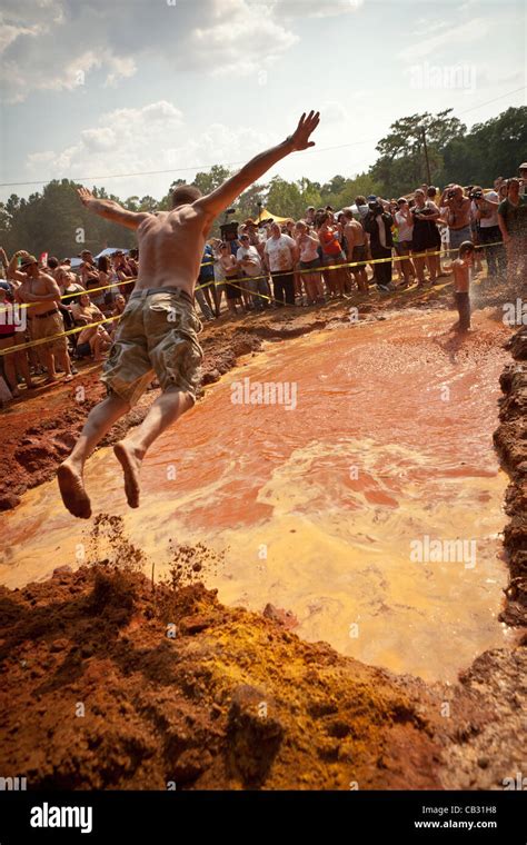 A Competitor In The Summer Redneck Games Takes A Belly Flop Into A Mud
