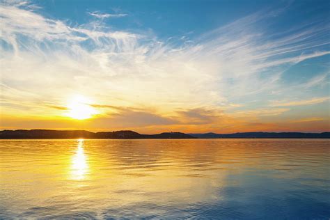 Sunset Over Water Photograph By Focusstock