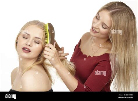 She S Doing Her Friend S Hair Brushing Her Hair Stock Photo Alamy