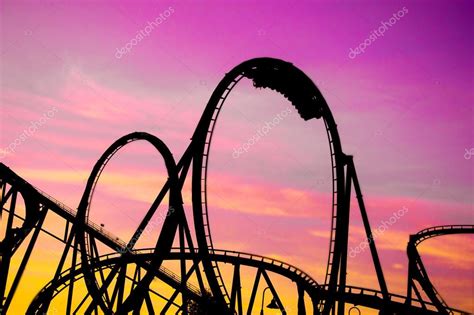 Colorful Silhouette Of A Roller Coaster At Sunset After A Sunny