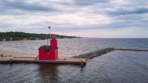 Red Lighthouse On Great Lakes With Waves And Beach Coast Stock Image