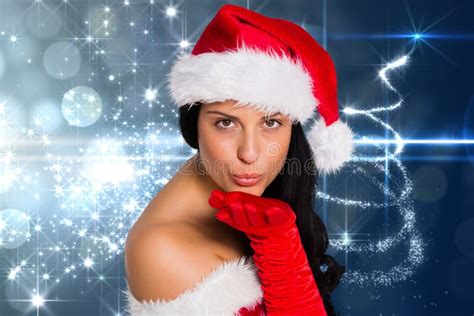 Beautiful Woman In Santa Costume Blowing A Kiss Against Digitally Generated Christmas Background