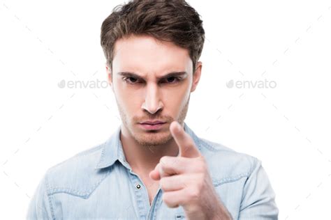 Portrait Of Serious Handsome Man Pointing At You Isolated On White
