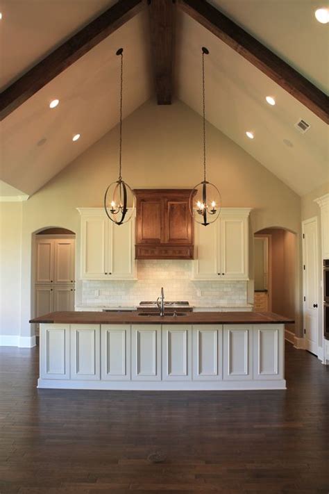 Skylights add valuable natural light and pendant. Vaulted Ceiling, wood counter-top island in kitchen ...