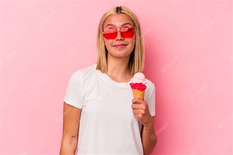 Premium Photo Young Venezuelan Woman Eating An Ice Cream Isolated On Pink Background Dreaming