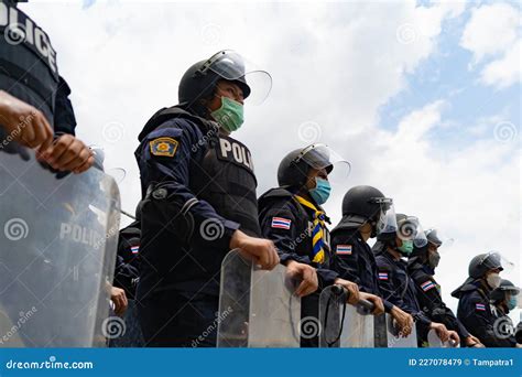 Police Officer Team With Weapons And Riot Shield Protection Violence Against Demonstrators And