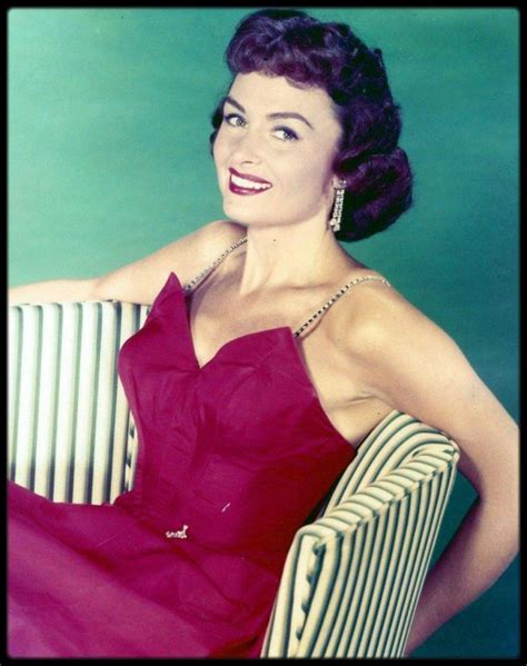 A Woman In A Red Dress Sitting On A Chair